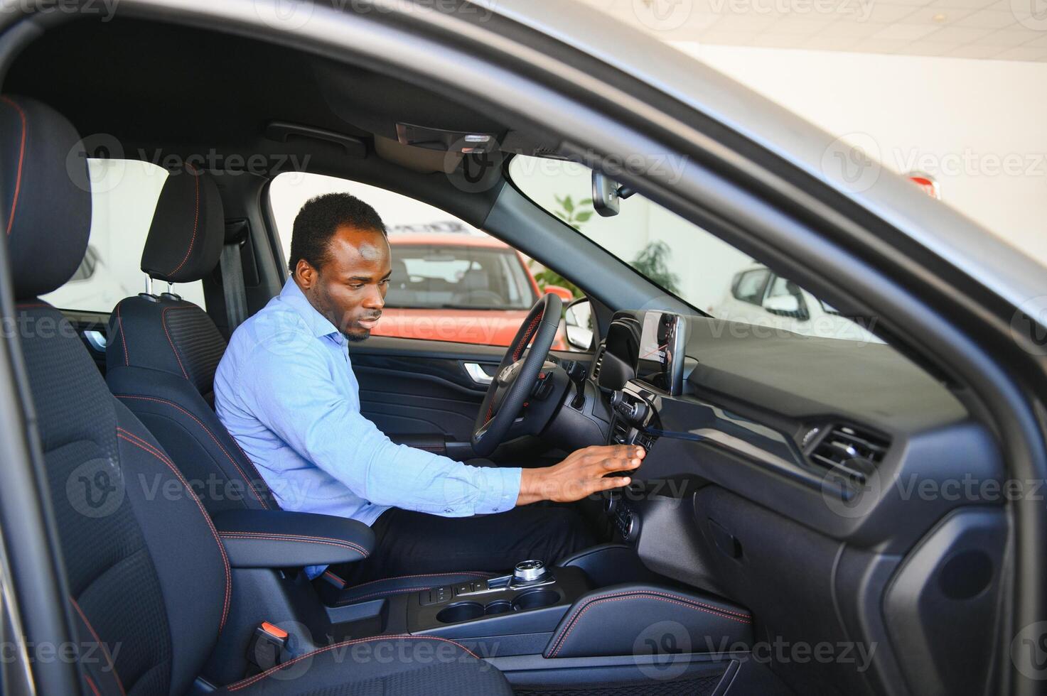 bil ägare. glad afro kille leende, Sammanträde i ny bil körning från återförsäljare affär foto
