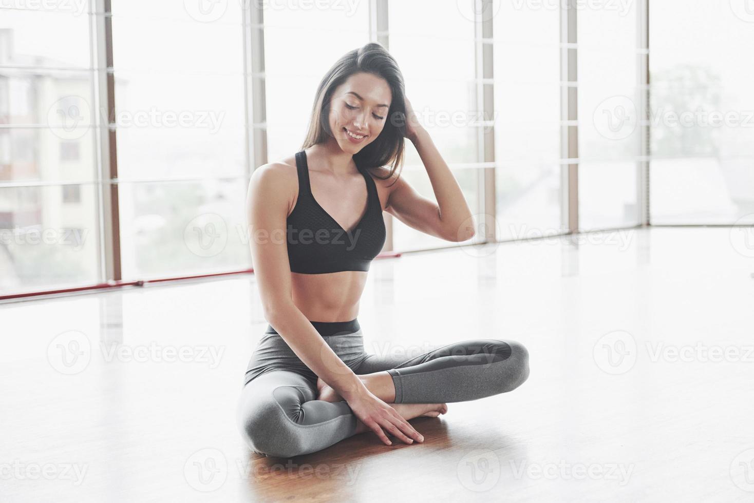 en sport tjej som gör en stretch. en kvinna försöker vara i god form foto