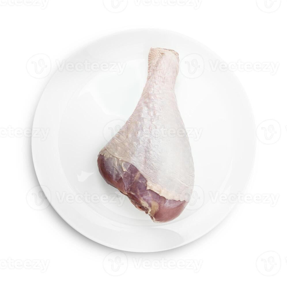 ett rå Kalkon ben på en vit tallrik foto