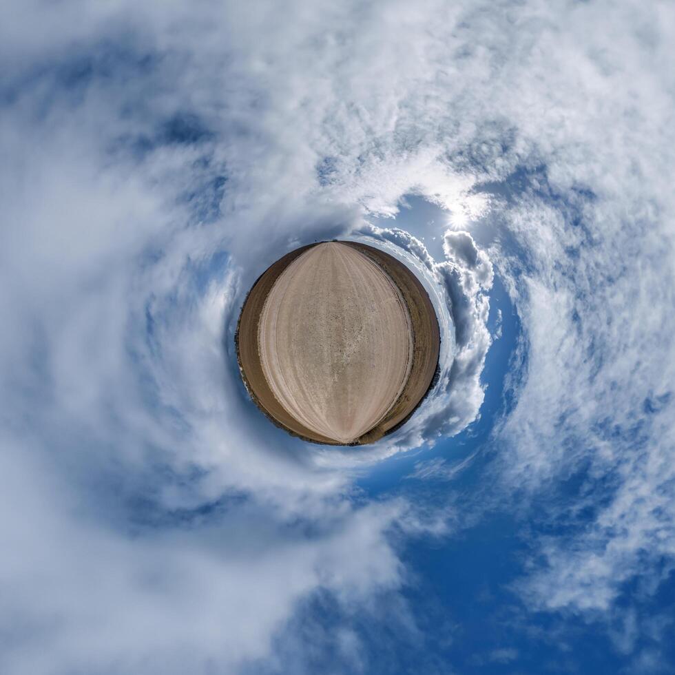 enkel mycket liten planet utan byggnader i blå himmel med skön moln. omvandling av sfärisk panorama 360 grader. sfärisk abstrakt antenn se. krökning av Plats. foto