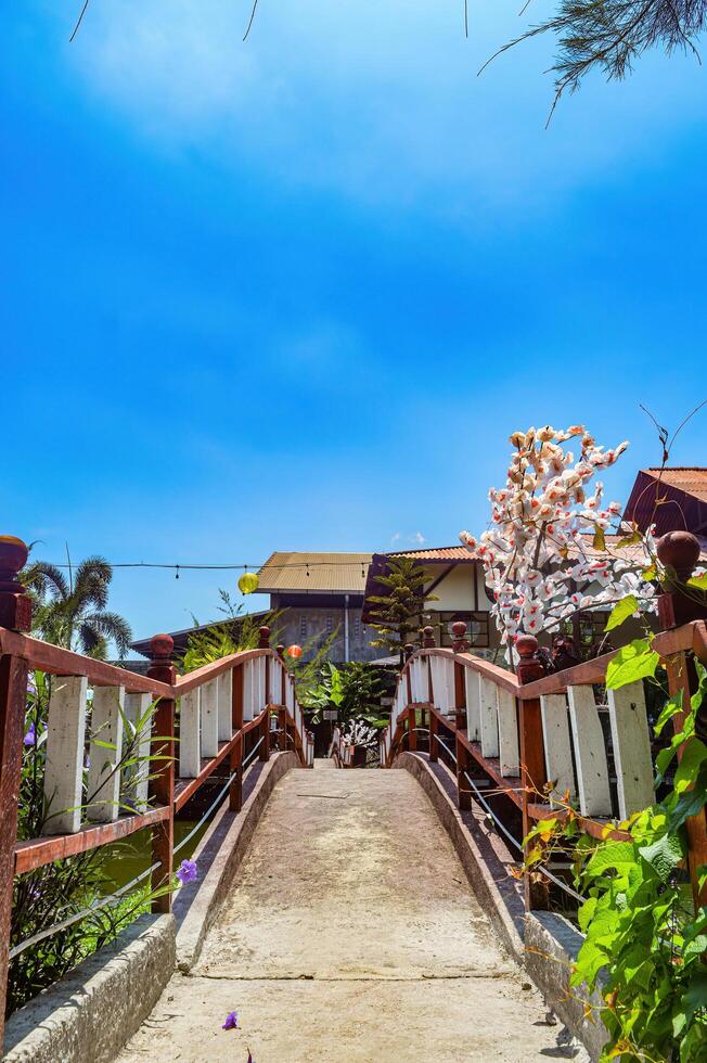 båge bro i en japansk stil trädgård under de dag i indonesien foto