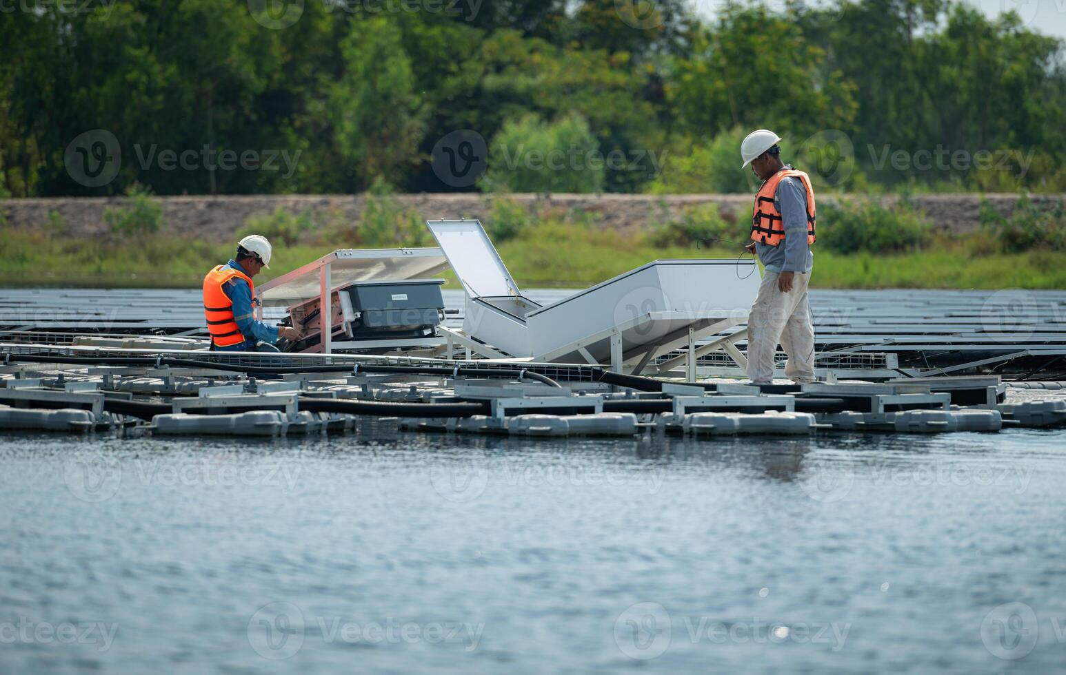 både av tekniker är för närvarande utvärdera och reparation de överföring terminaler för elektricitet genererad förbi sol- energi i en flytande sol- kraft systemet. foto