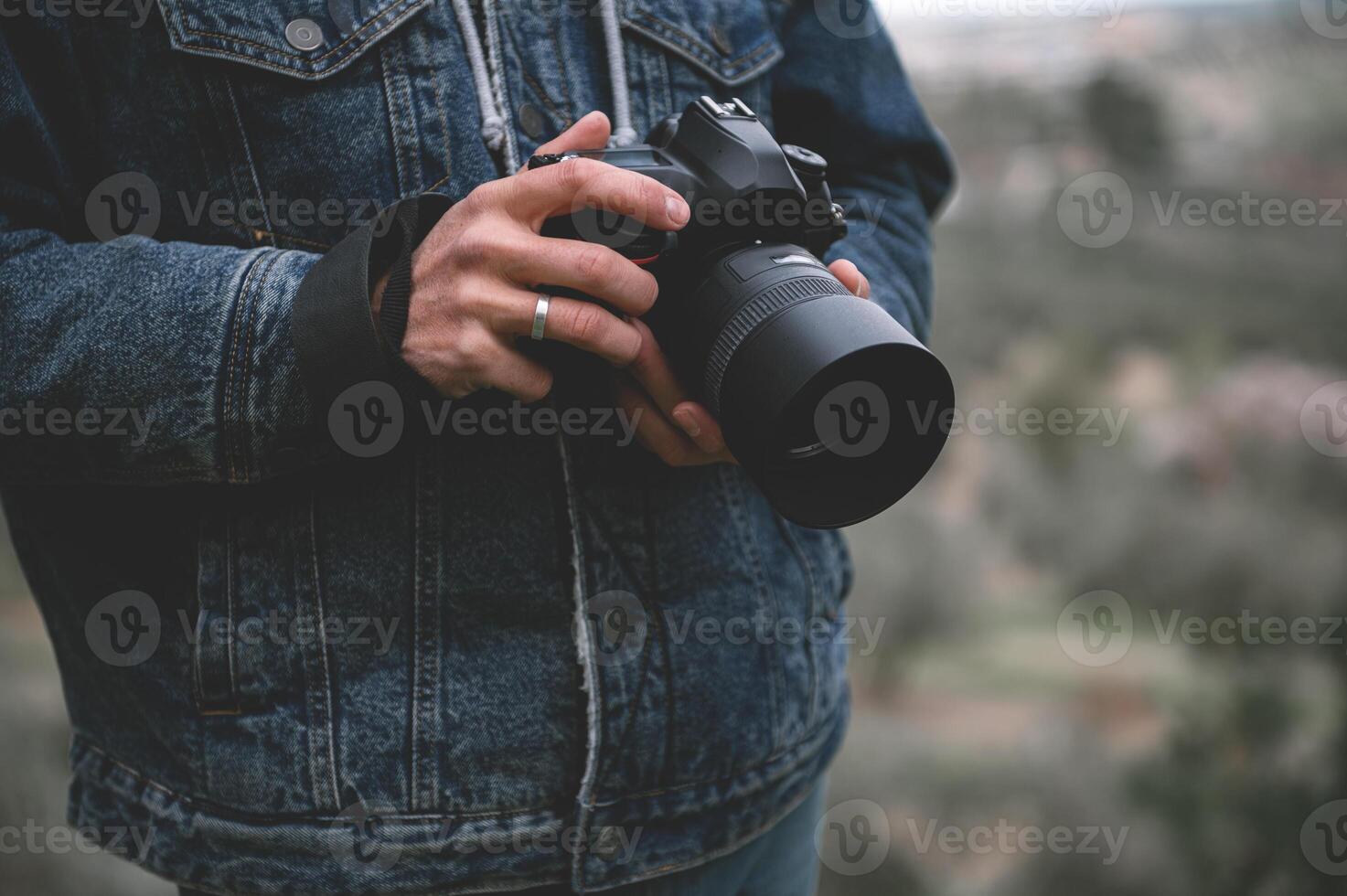 närbild professionell kamera i de händer av manlig resande fotograf foto