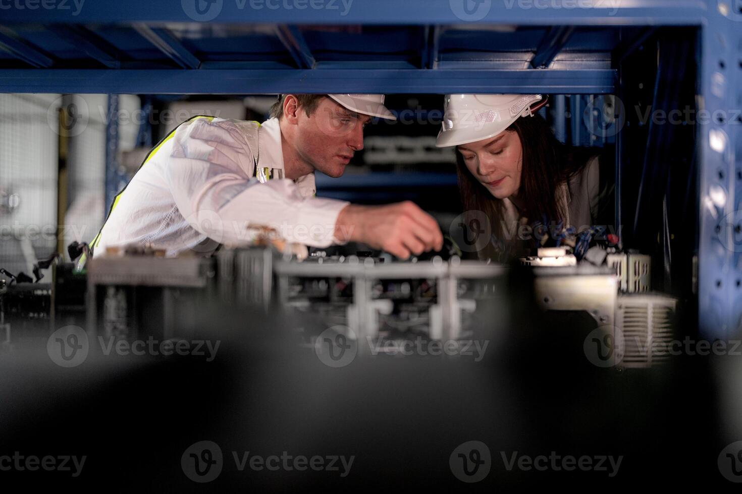 tekniker ingenjörer team kontroll de maskin och underhåll service. arbetare ser på reserv delar i stock på lager fabrik. arbetare med en checklista ser på del av maskin delar. foto