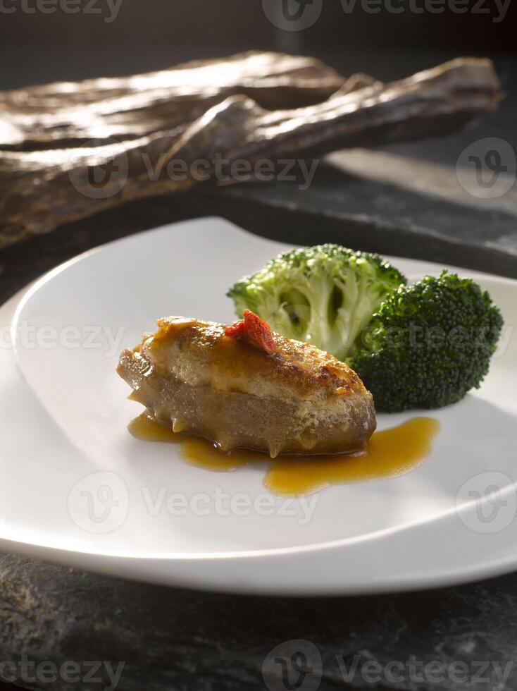 bräserad hav gurka med mald kött i brun sås eras i maträtt isolerat på tabell topp se av mat foto