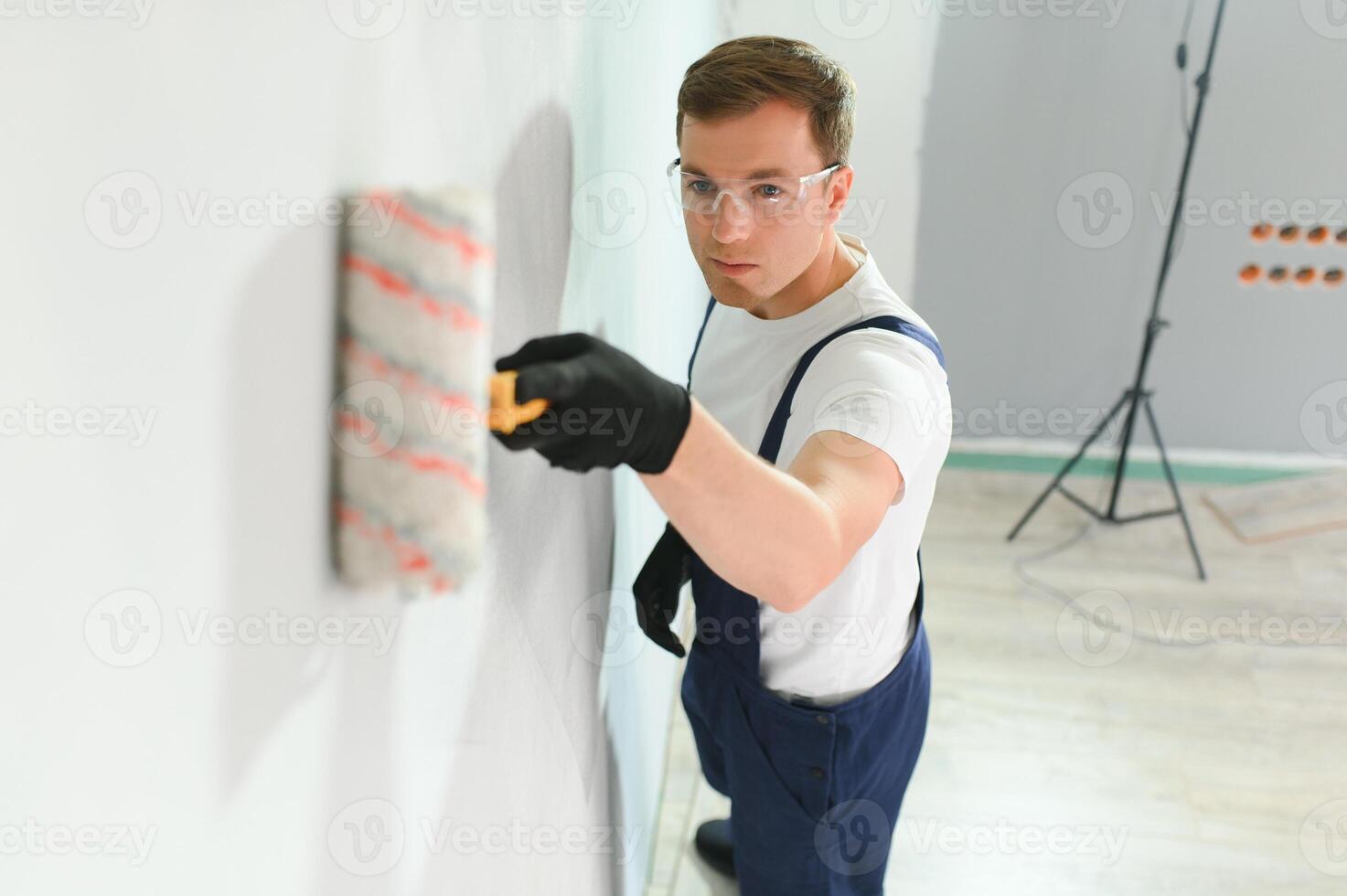 ung arbetstagare målning vägg i rum foto