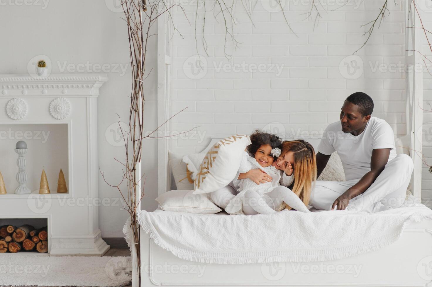 Lycklig interracial par med deras liten dotter på Hem foto