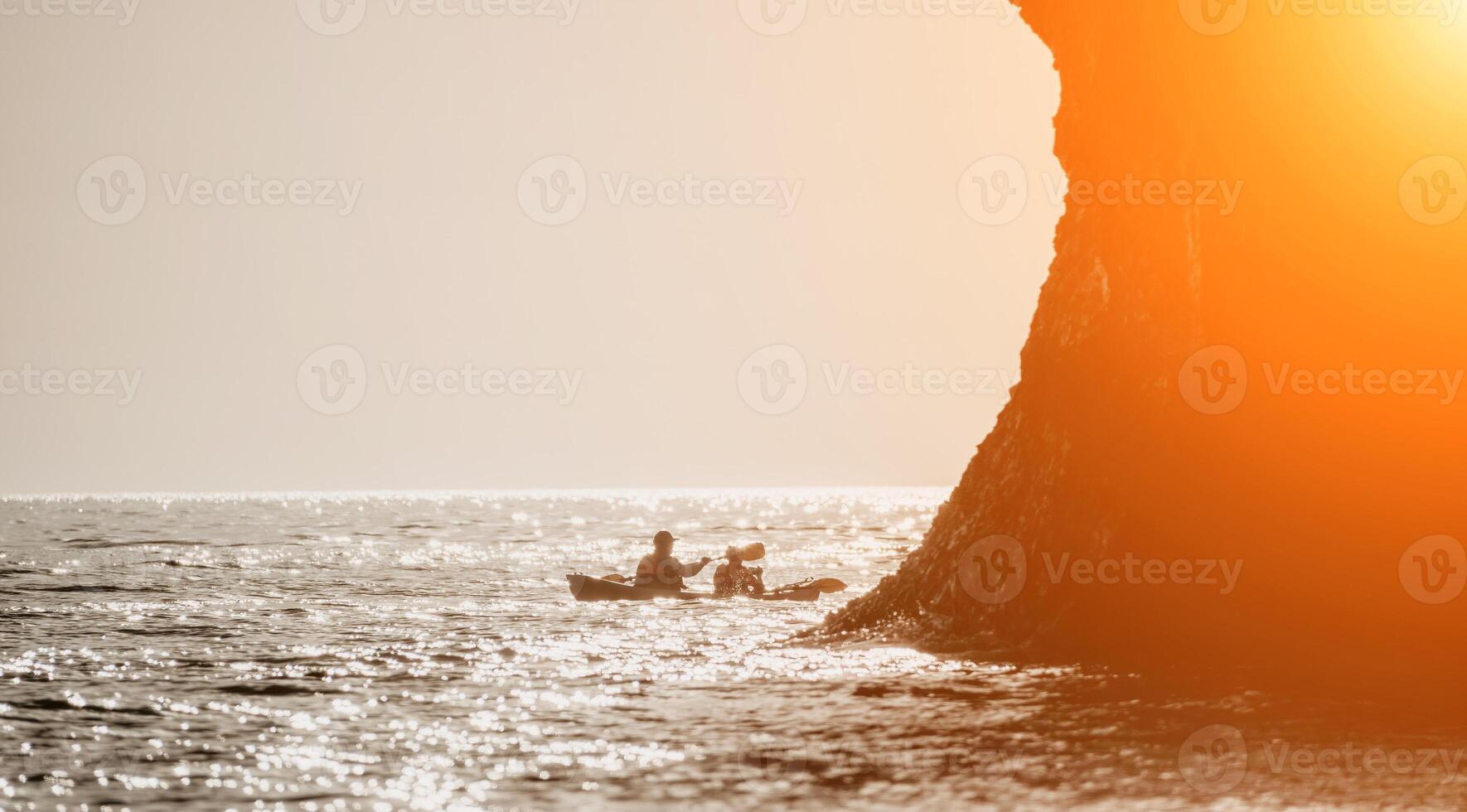 Lycklig par kajaker i ett uppblåsbar kajak på de hav på solnedgång. par kanotpaddling i de hav nära de ö med berg. människor Kajakpaddling i liv jackor segla. tillbaka se foto