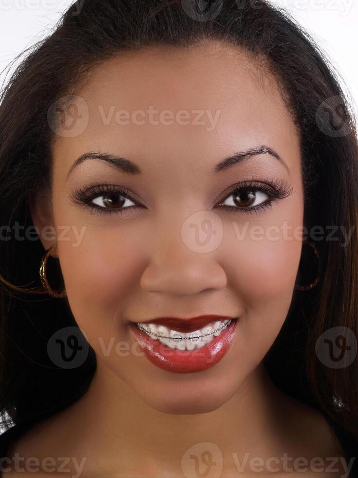 leende ung svart kvinna med tandställning övre tänder foto