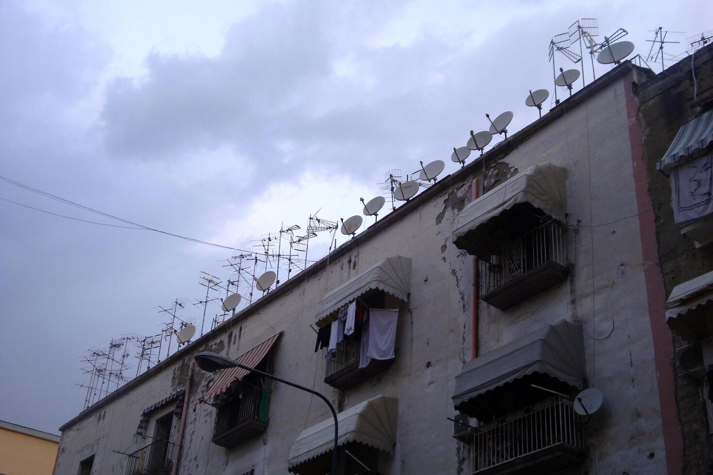 Neapel, Italien, Europa - augusti 15, 2019 satellit maträtter på de tak av en stadens centrum byggnad foto