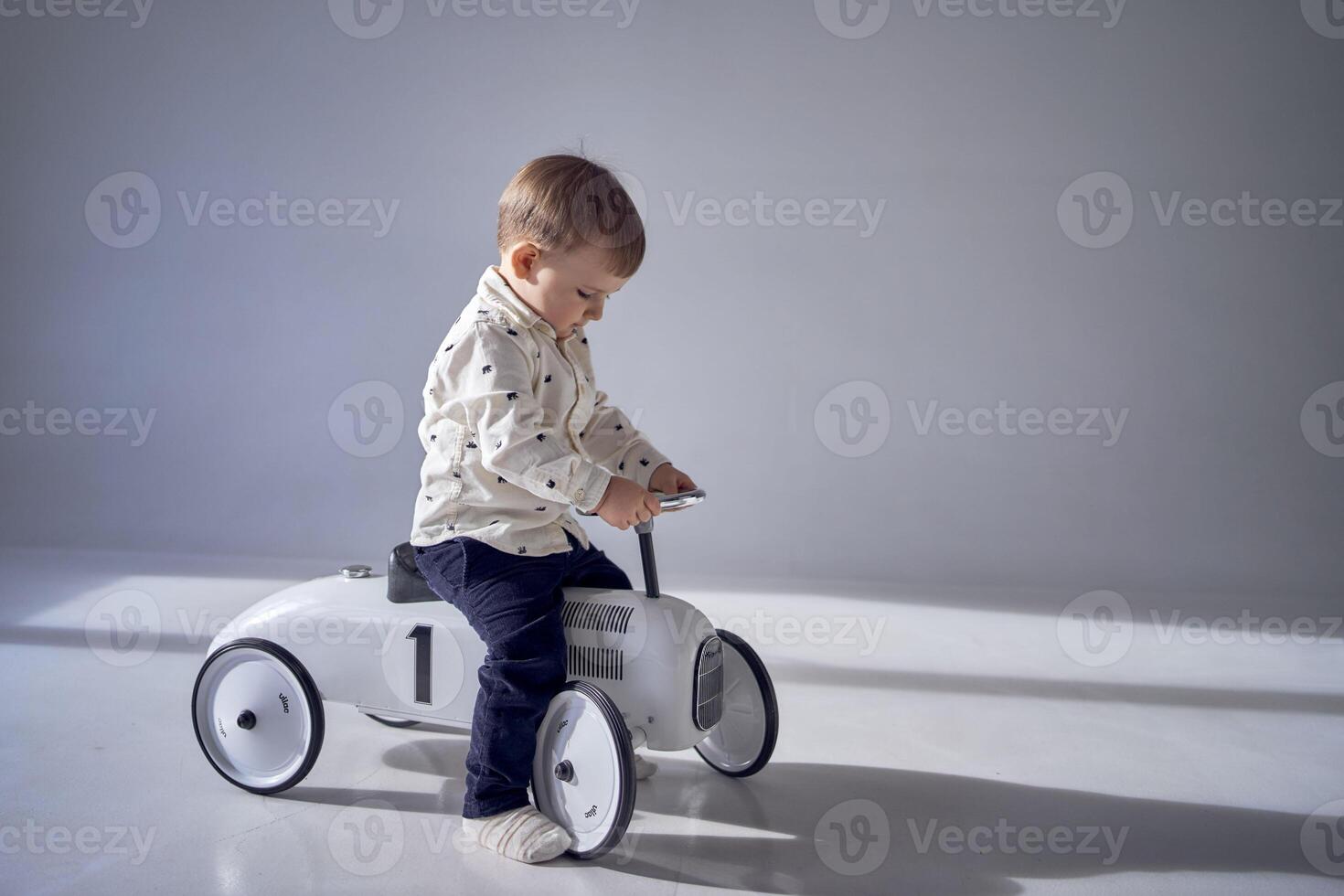 en litet barn är entusiastiskt spelar med hans leksak bil på hans födelsedag foto