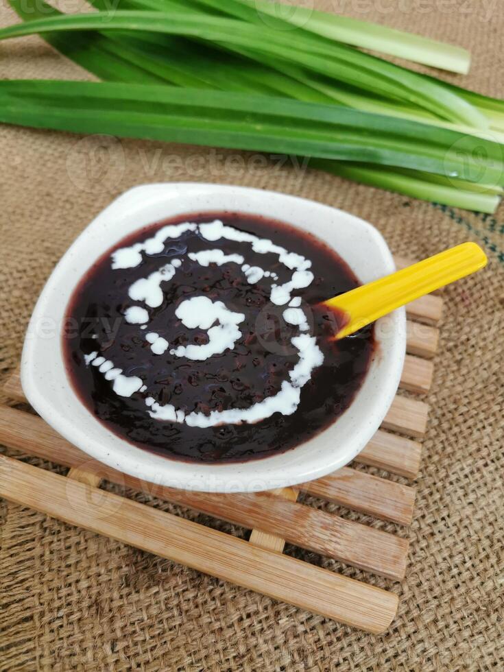 bubur hitam med sked eras skål isolerat på tabell topp se av thai mat foto