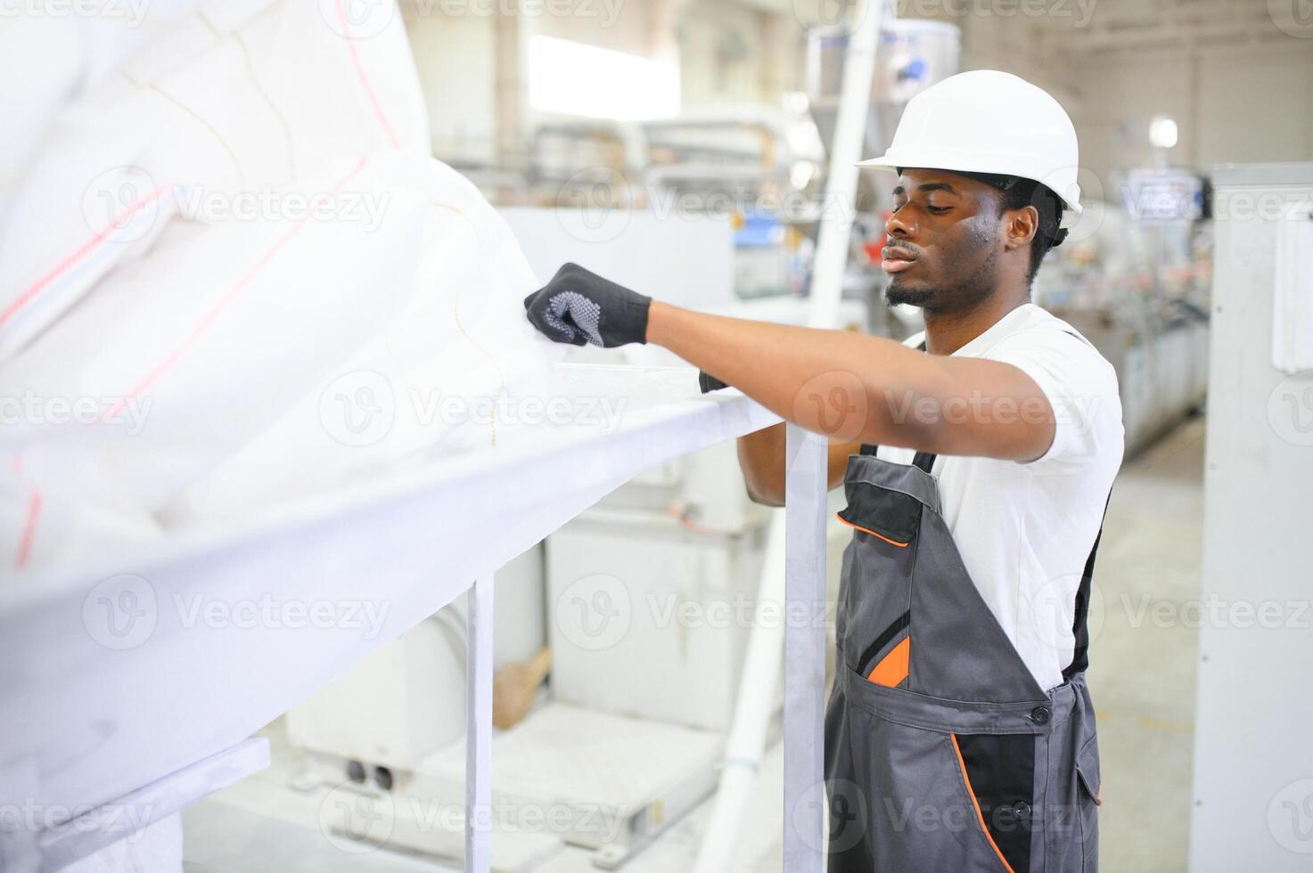 professionell tung industri ingenjör arbetstagare bär enhetlig, glasögon och hård hatt i en fabrik foto