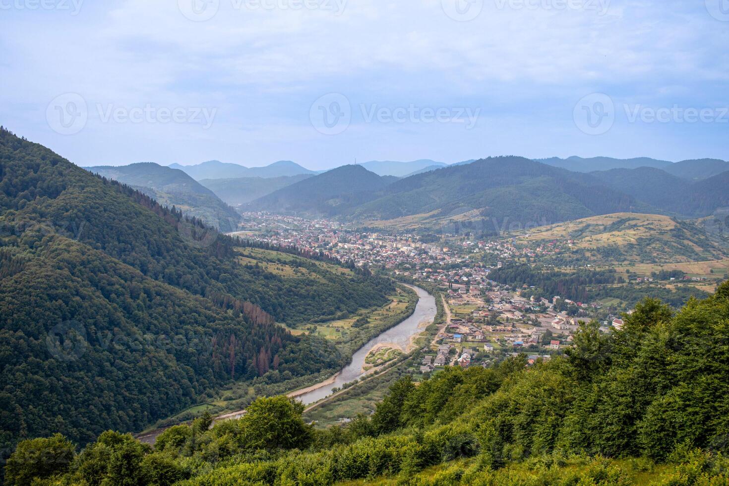 karpater bergen räckvidd, ukraina. karpater se av en berg flod och by foto