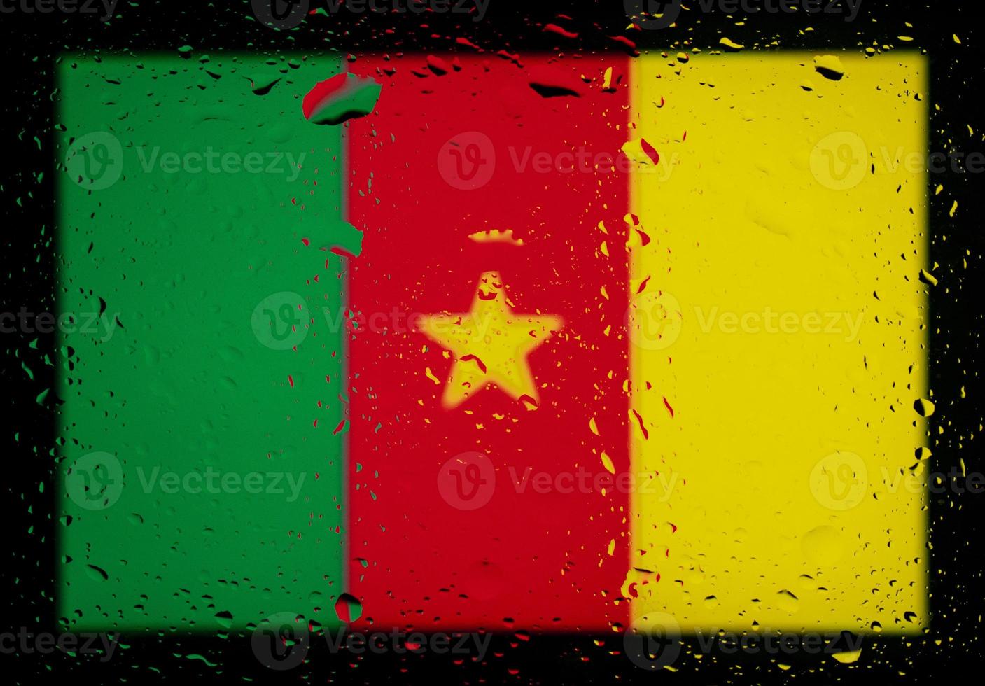 droppar vatten på Kamerun flagga bakgrund. kort skärpedjup. selektiv fokusering. tonad. foto