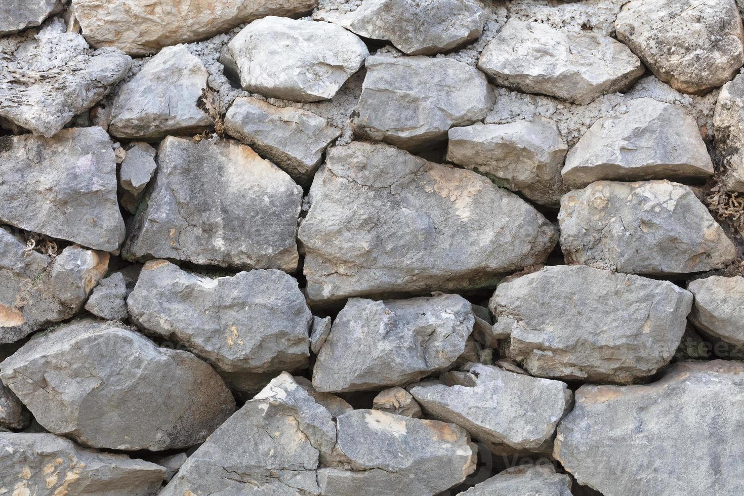 stenmur från en stor kullerstenssandsten närbild foto