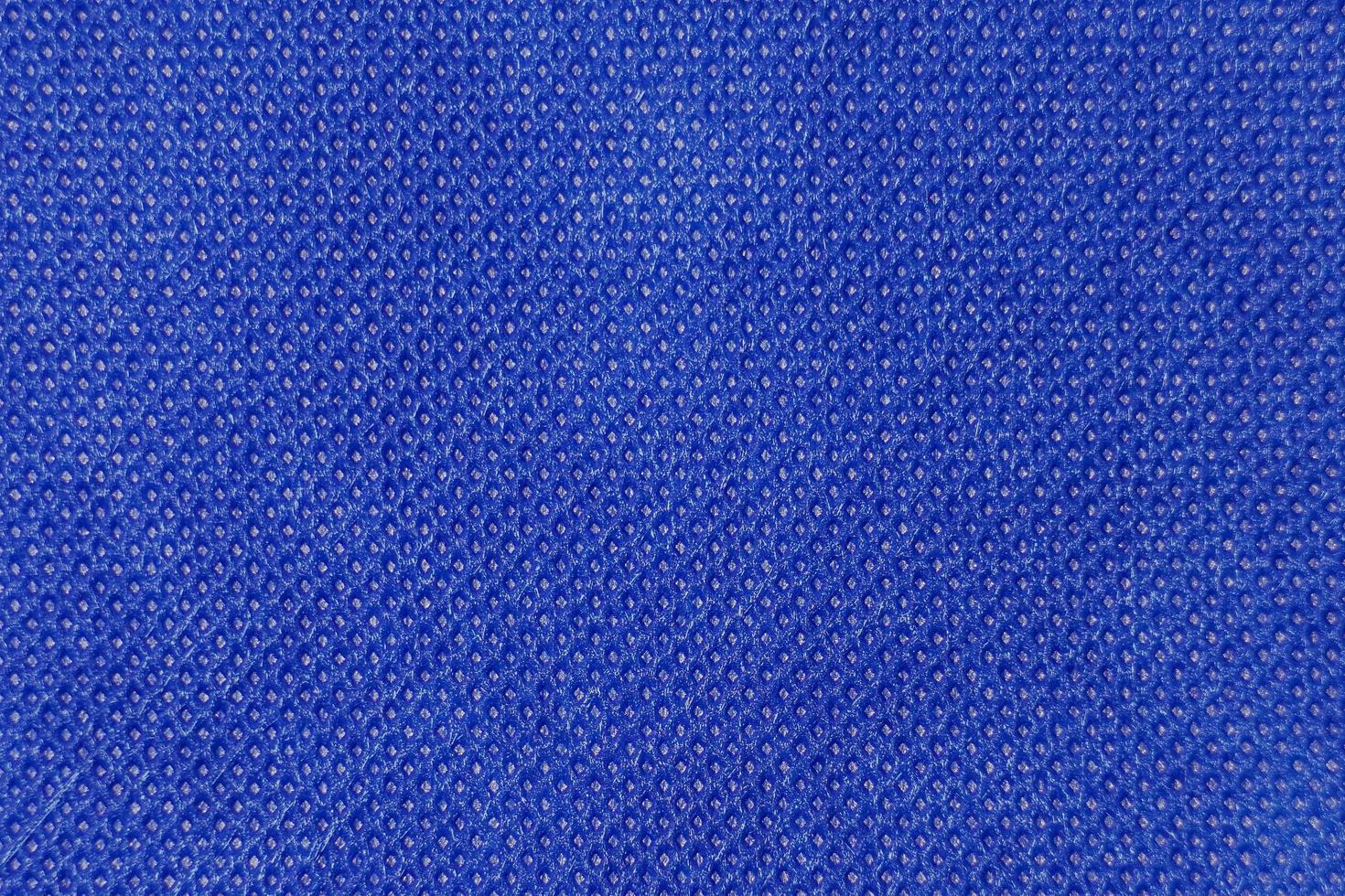 den abstrakta ytan på det vävda tyget i blått för ett bakgrundsmönster. en detaljerad elementgrafik för en kreativ design. foto