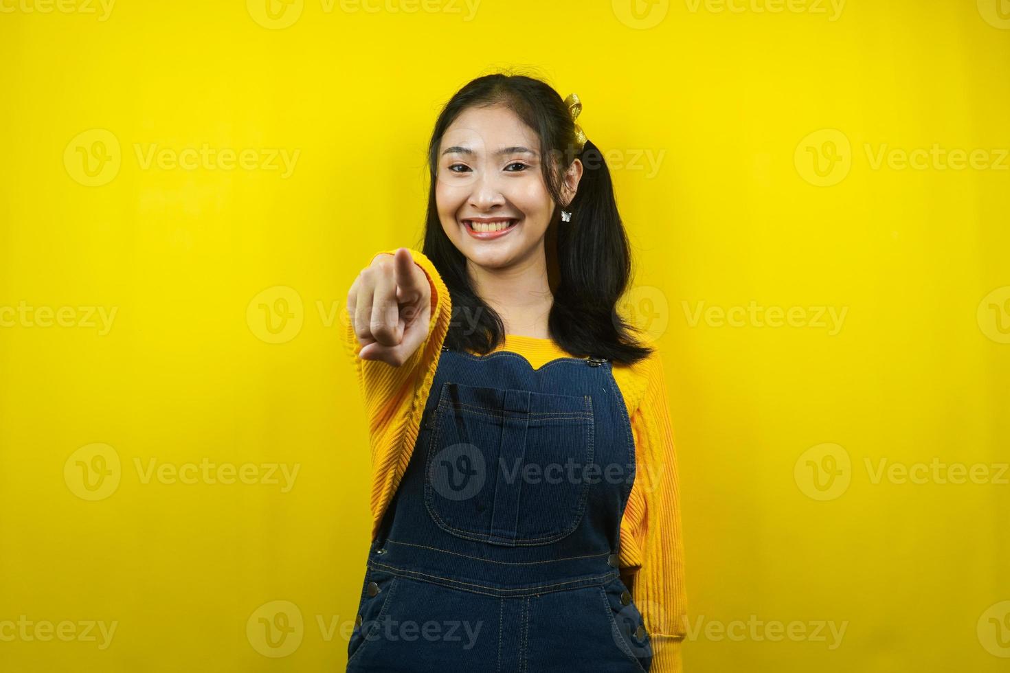 söt och söt ung kvinna glad, självsäker, hand pekar på kameran, hand pekar på publiken, isolerad foto