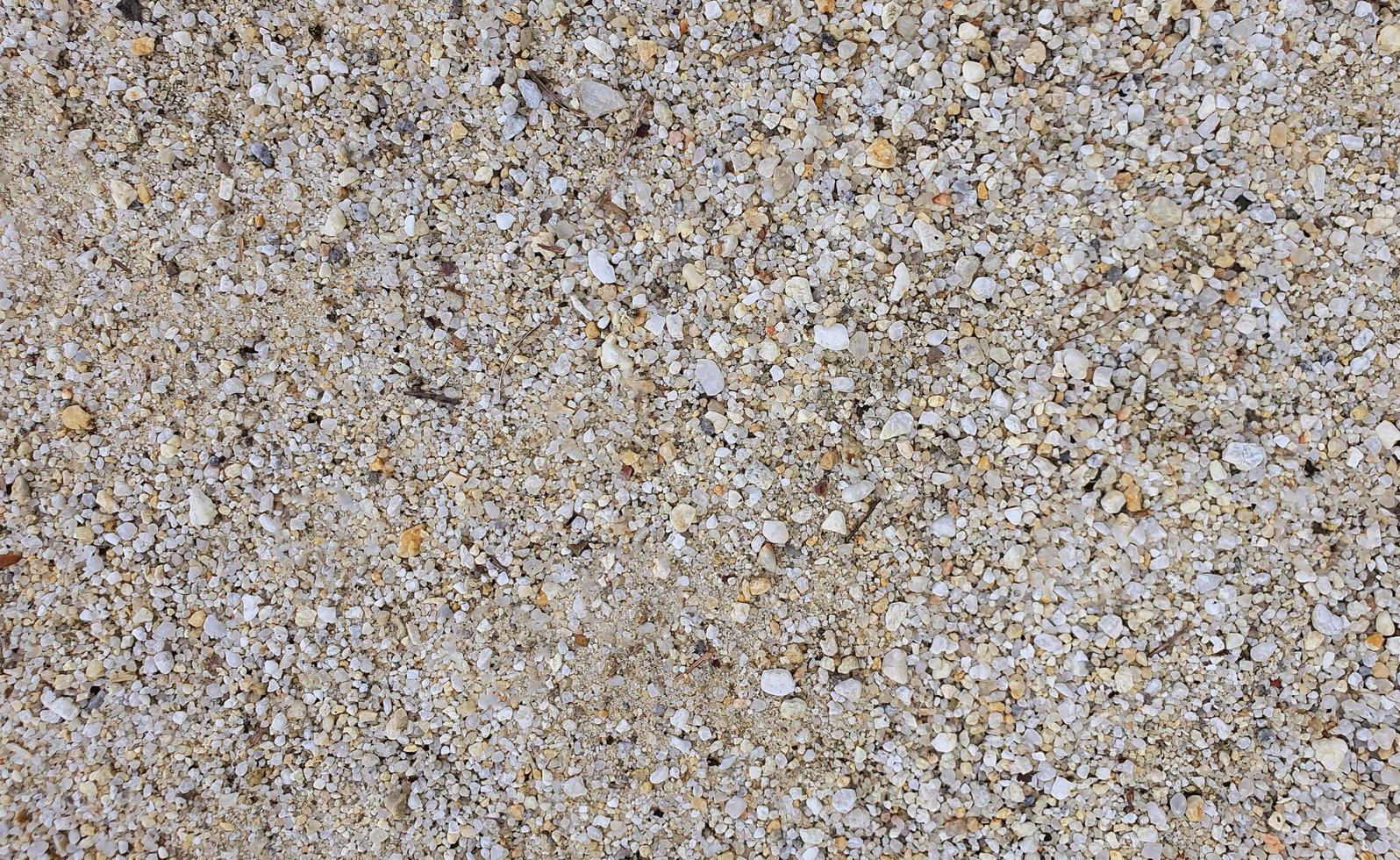 vit sand och små stenar för bakgrund foto