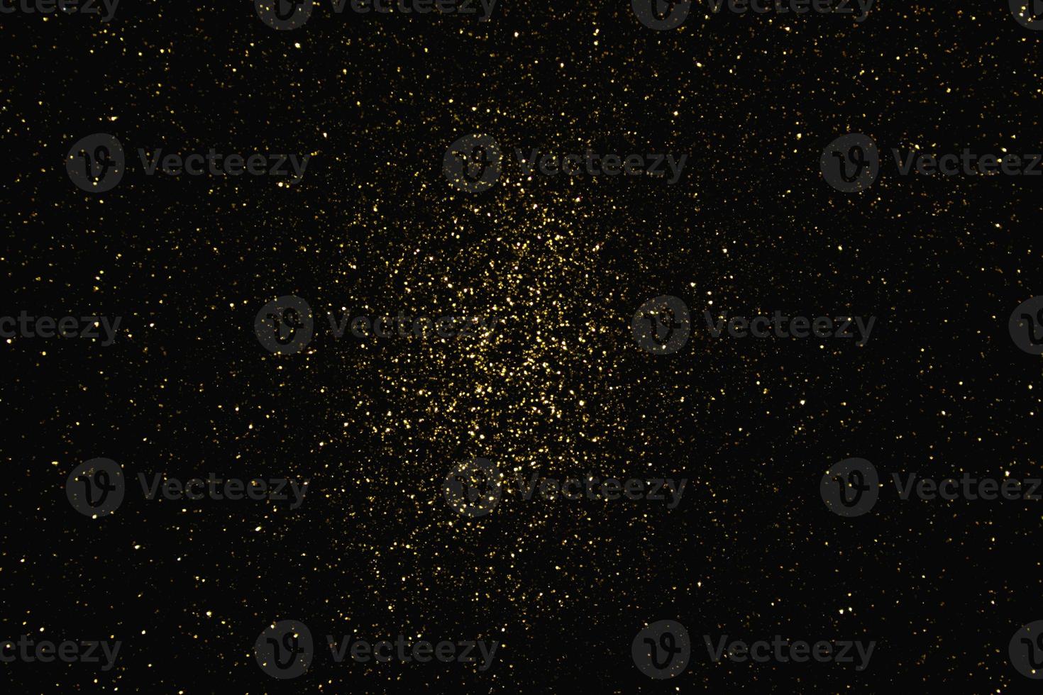 guld abstrakt mönster glitter stardust gnistrande ljus grunge på svart. foto