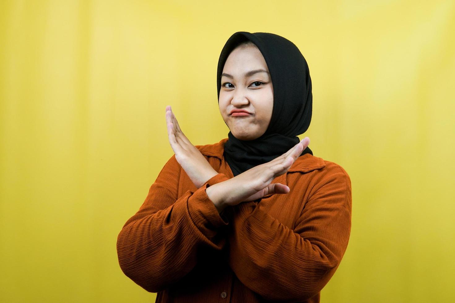 vacker asiatisk ung muslimsk kvinna med korsade armar, händer som visar vägran, händer som visar förbud, händer som visar ogillande, isolerad foto