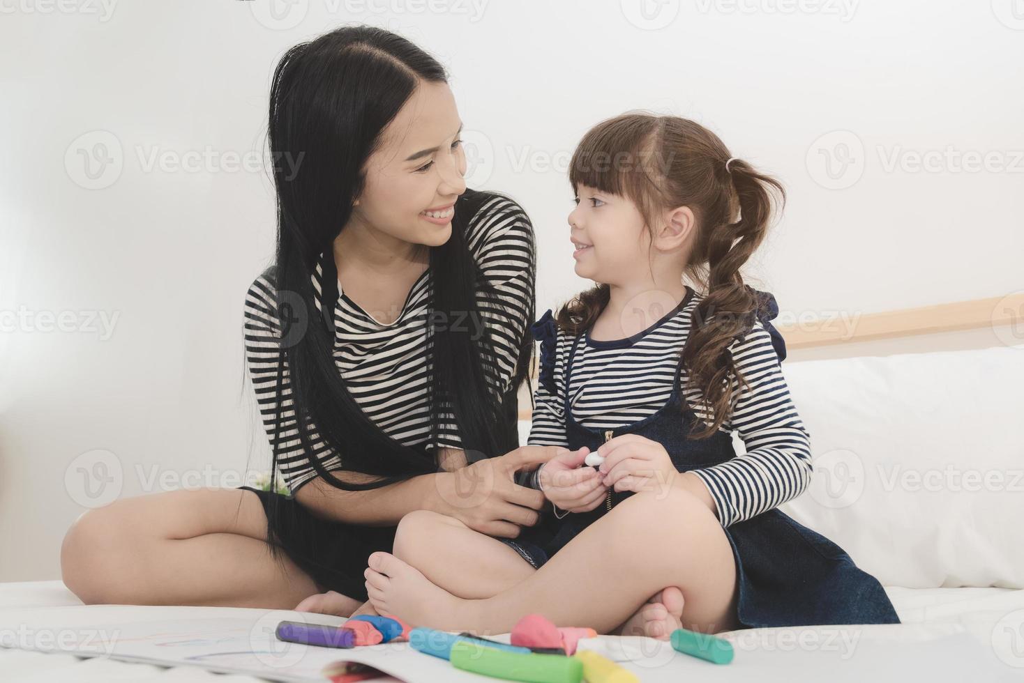 lycklig kärleksfull familj, asiatisk ung mamma leker med sin dotter i barnens rum. fotodesign för familj, barn och glada människor koncept. foto