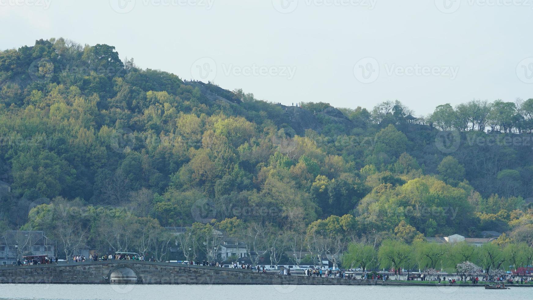 de vackra sjölandskapen i hangzhou-staden i Kina på våren med den fridfulla sjön och de friska gröna bergen foto