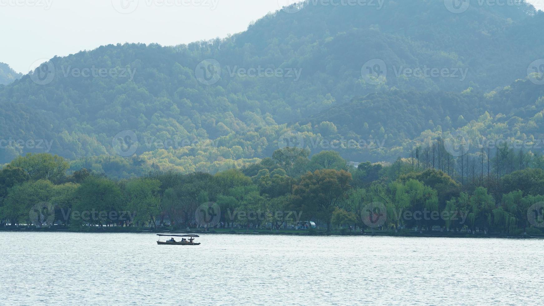 de vackra sjölandskapen i hangzhou-staden i Kina på våren med den fridfulla sjön och de friska gröna bergen foto