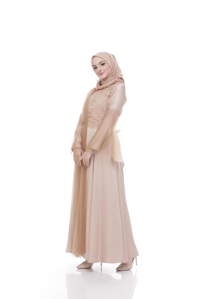 helkroppsporträtt av dam använder en bröllopsklänning, bröllopsmakeup på hijab. malaysiska eller indonesien bröllopsklänning, skönhet eller eidul fitri koncept. vacker sydostasiatisk muslimsk kvinna poserar i islamsklänning foto