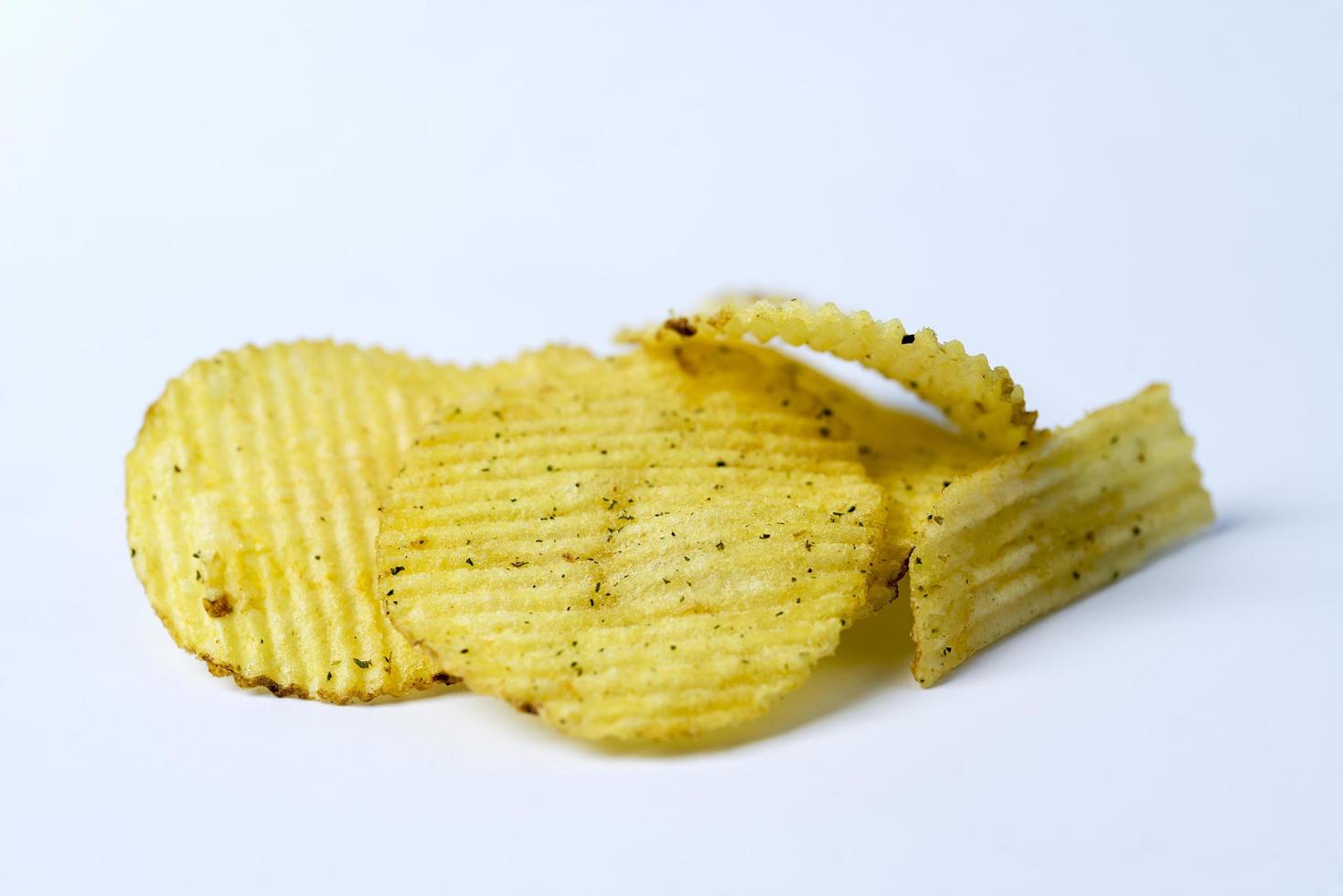 stekt potatis, fluted chips på en vit bakgrund. foto