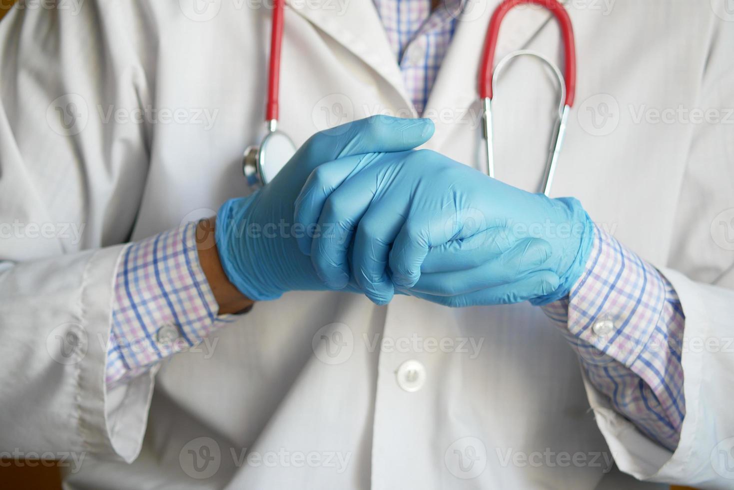 läkare hand med medicinska handskar som visar stödtecken, foto