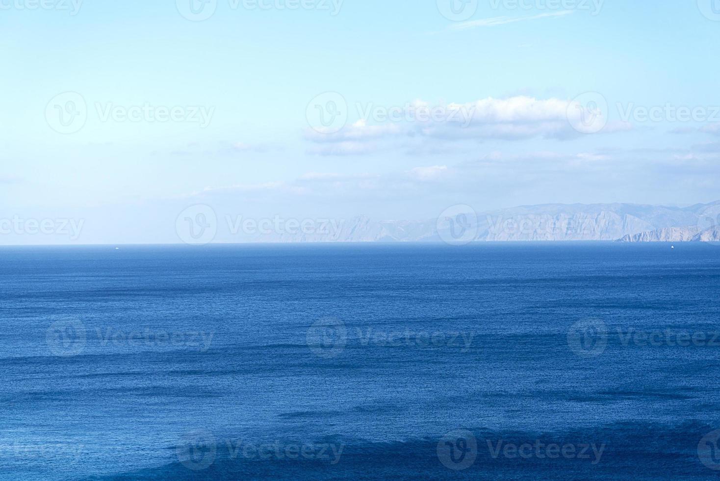 vackra vita moln på blå himmel över lugnt hav med solljusreflektion, bali Indonesien. lugn havsharmoni av lugn vattenyta. solig himmel och lugnt blått hav. foto