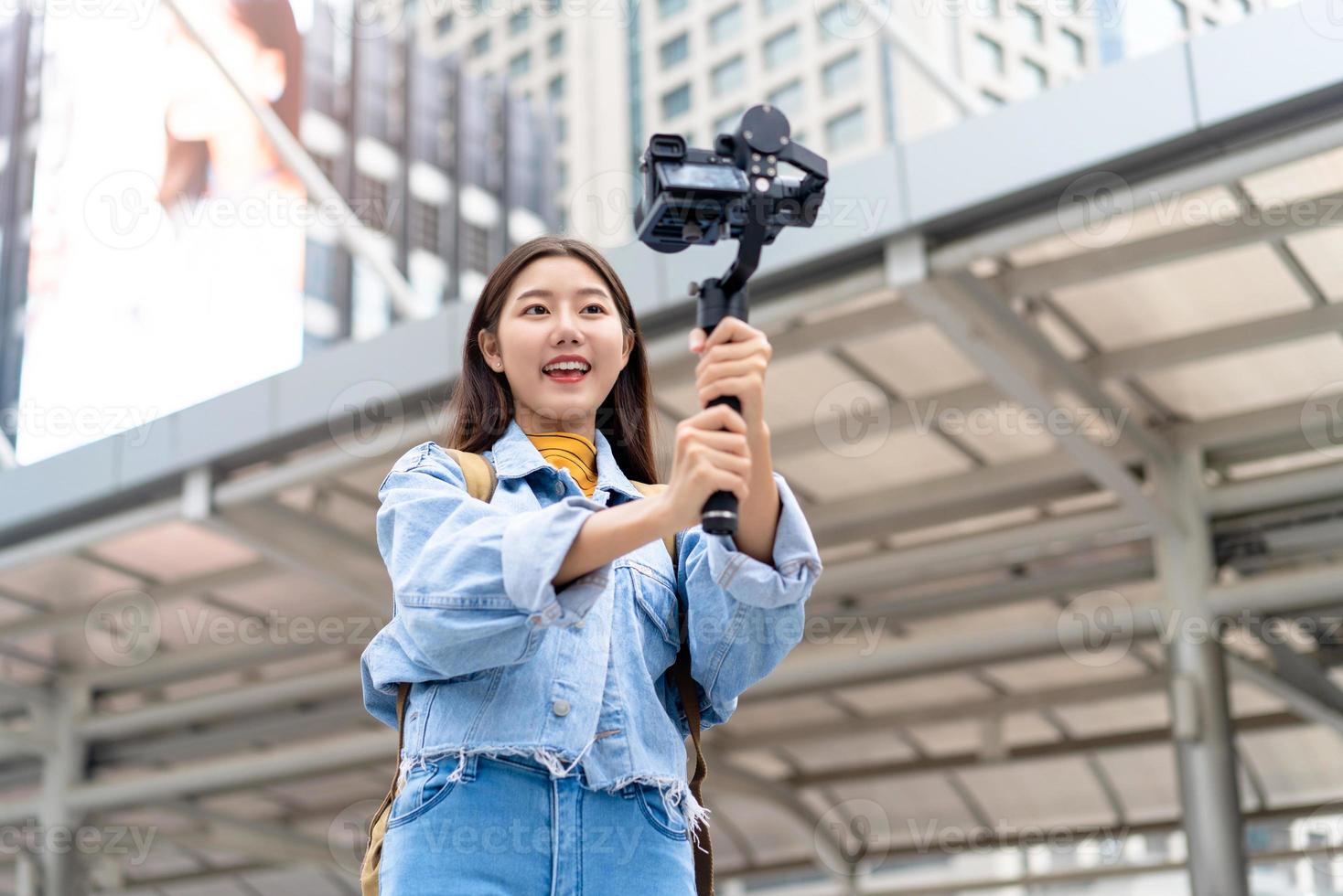 asiatisk kvinna turist resor vlogger tar selfie video i staden foto