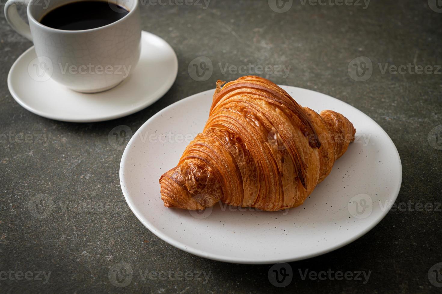 färsk croissant på vit platta foto