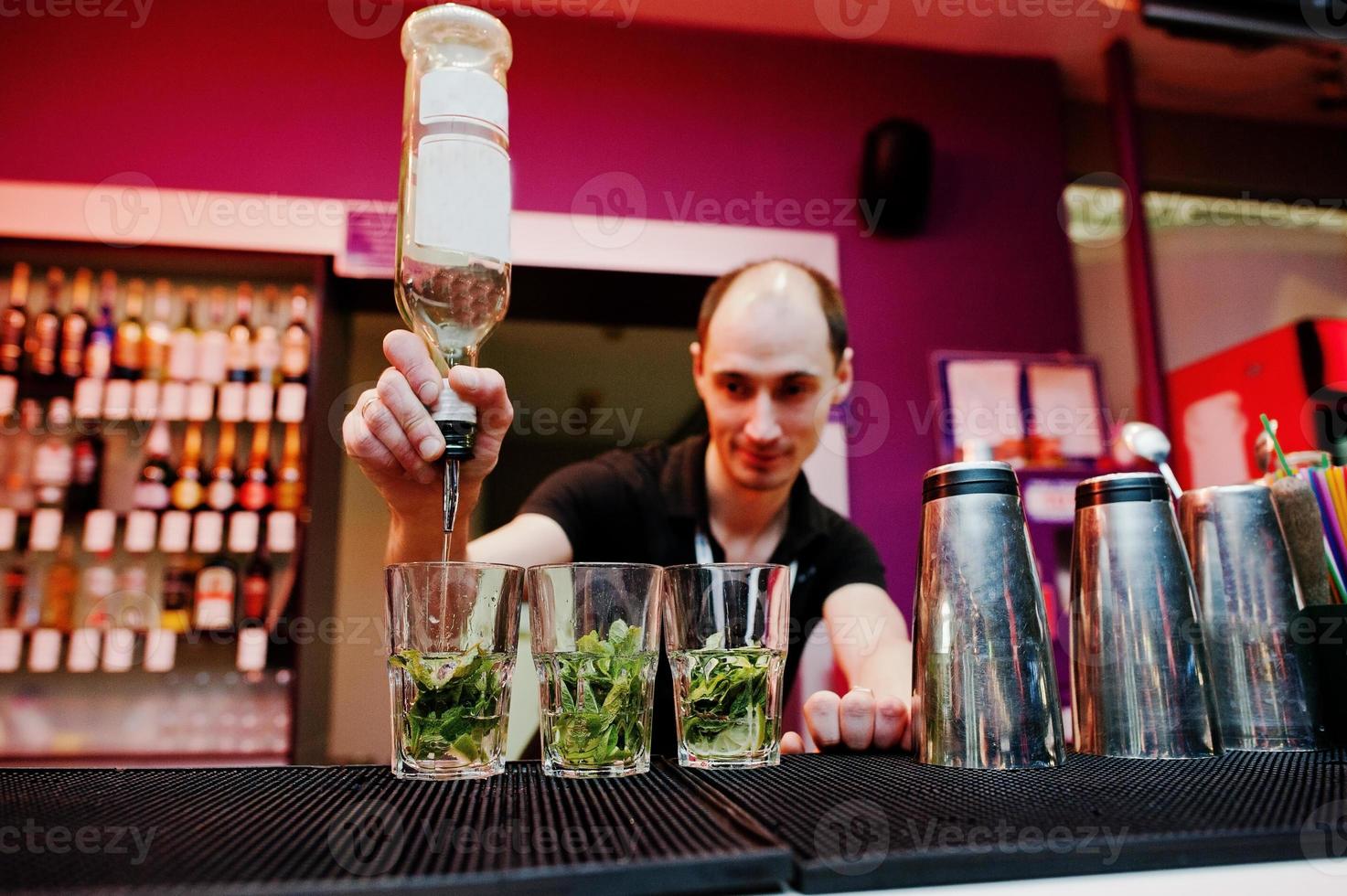 bartendern förbereder mojito cocktaildrink i baren foto