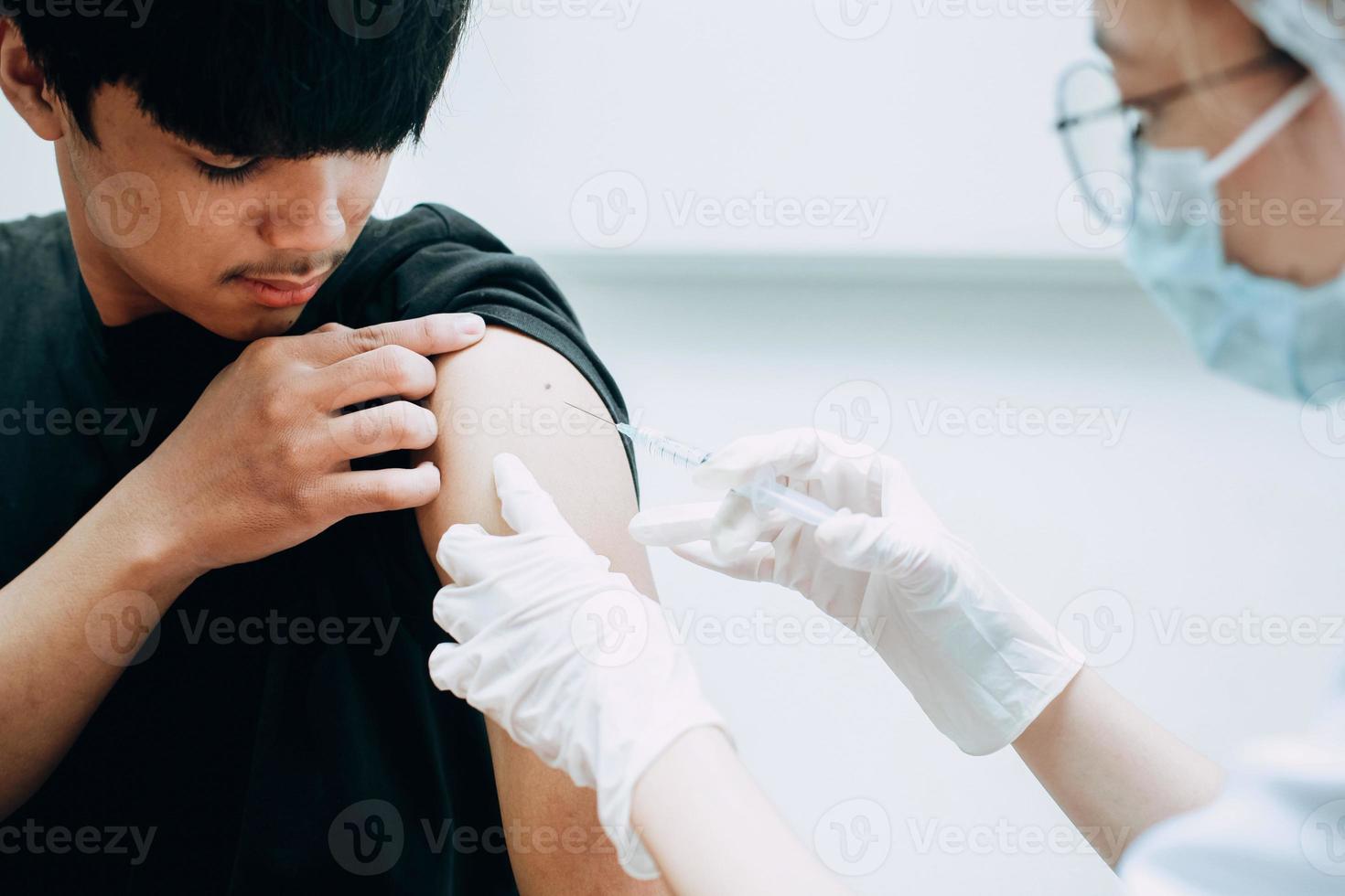 ung patient när han är i vaccininjektion av läkaren foto