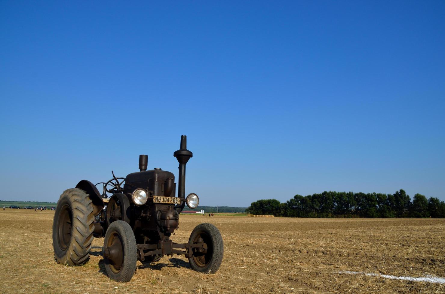 svart traktor på ett fält foto