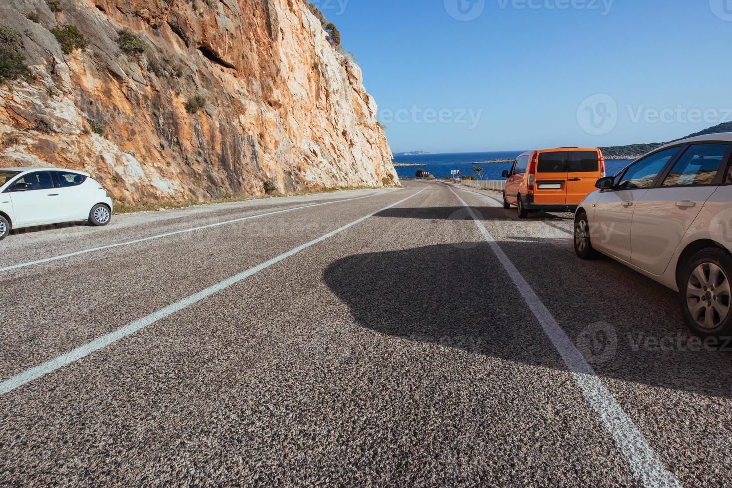 fantastisk asfalterad väg längs kusten, och bilar foto