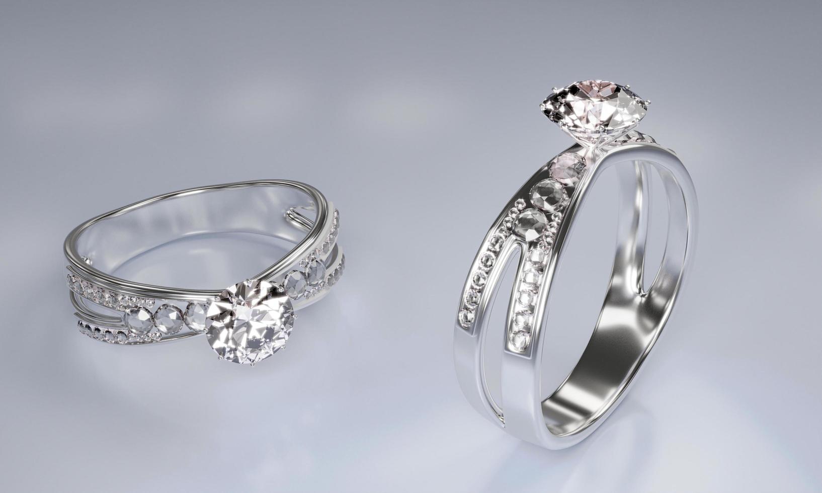 diamantringar gjorda av platinaguld dekorerade med många små diamanter placerade på en vit yta. 3d-rendering foto