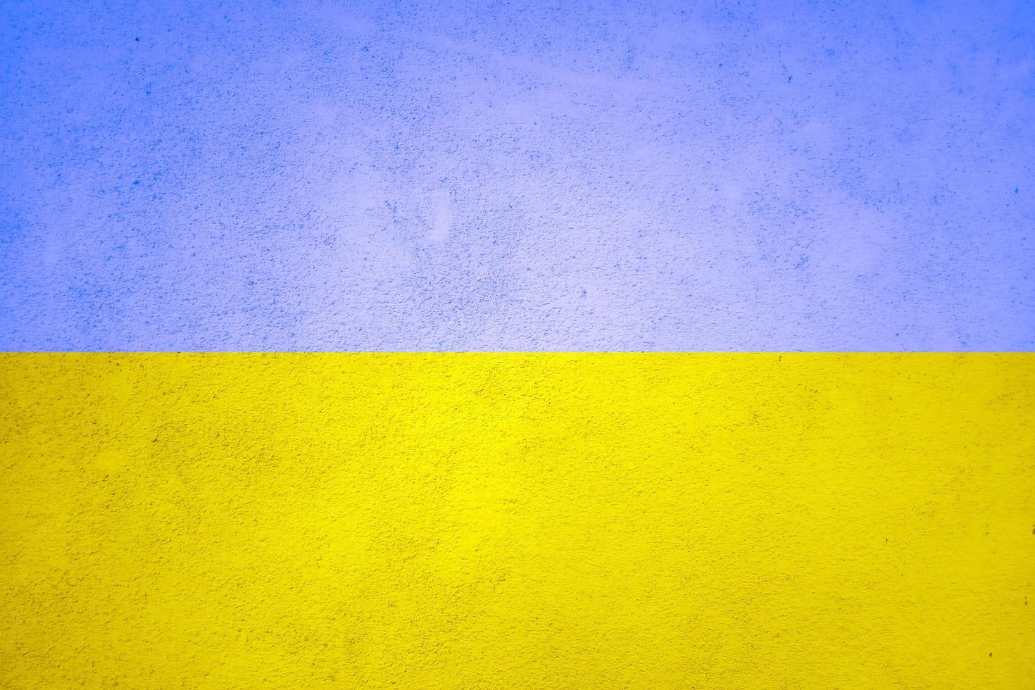 texturväggen är tonad med Ukrainas gulblå flagga. ukrainska nationella symboler bakgrund foto