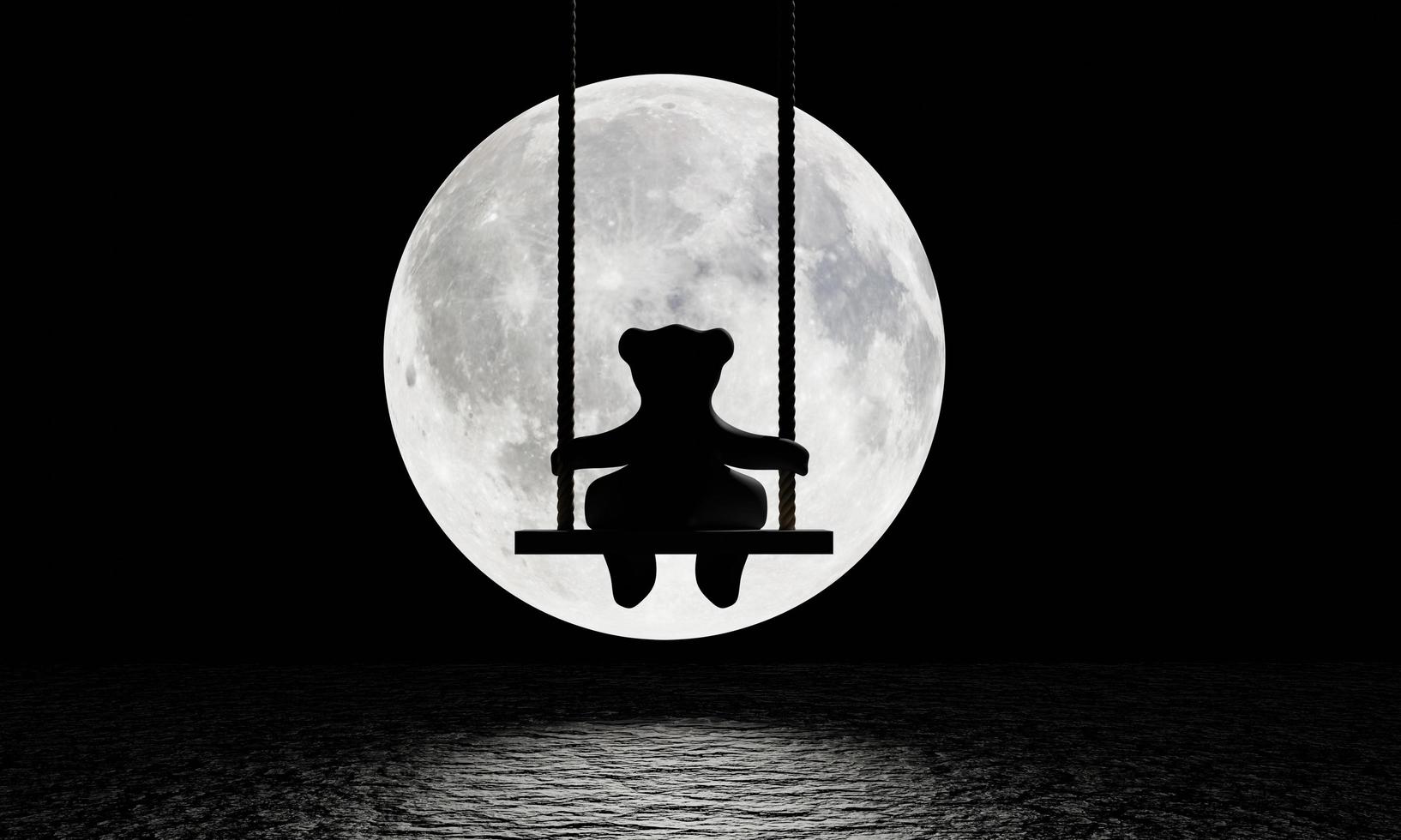 siluett av en nallebjörn som satt på en gunga där hängde ett stort rep. bakgrundsbilden är en stor måne som lyser med en reflektion på vattenytan eller floden. ledsen och ensam. 3d-rendering foto