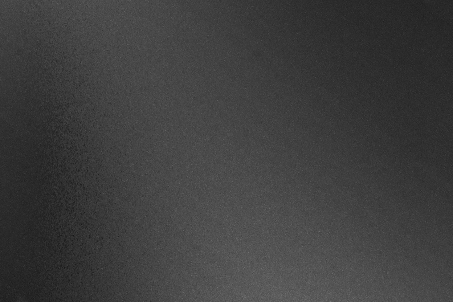 borstad svart metallisk ombord ark, abstrakt textur bakgrund foto