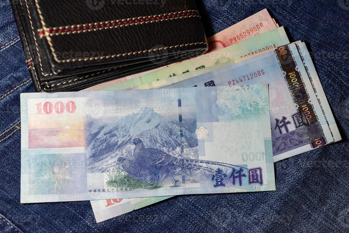 taiwanesiska pengar, taiwanesiska sedel, taiwanesiska dollar på jean bakgrund. foto