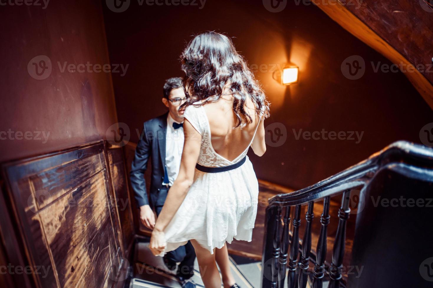 fashionabla unga par som står på trappan och kramar varandra foto