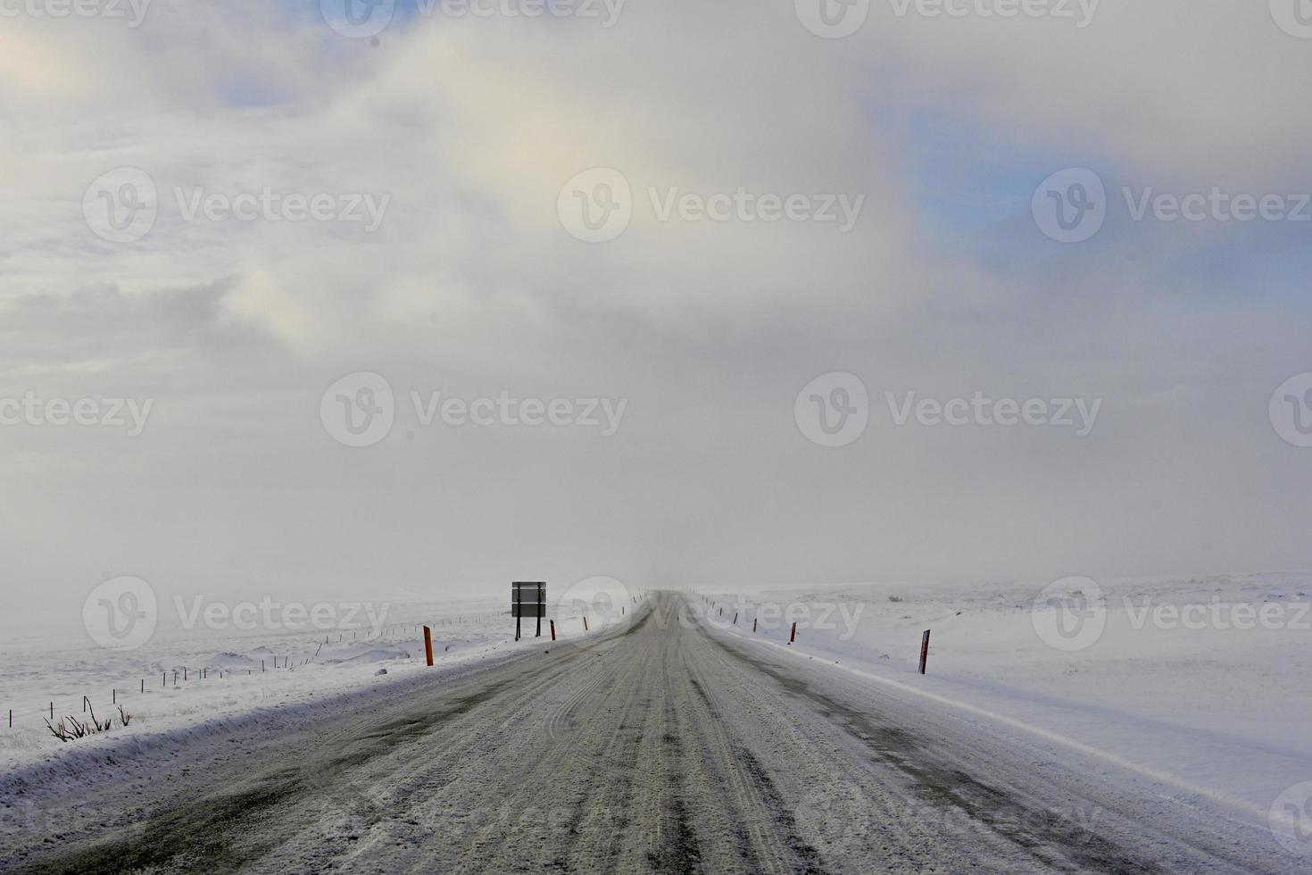 ändlös snöig väg på Island foto