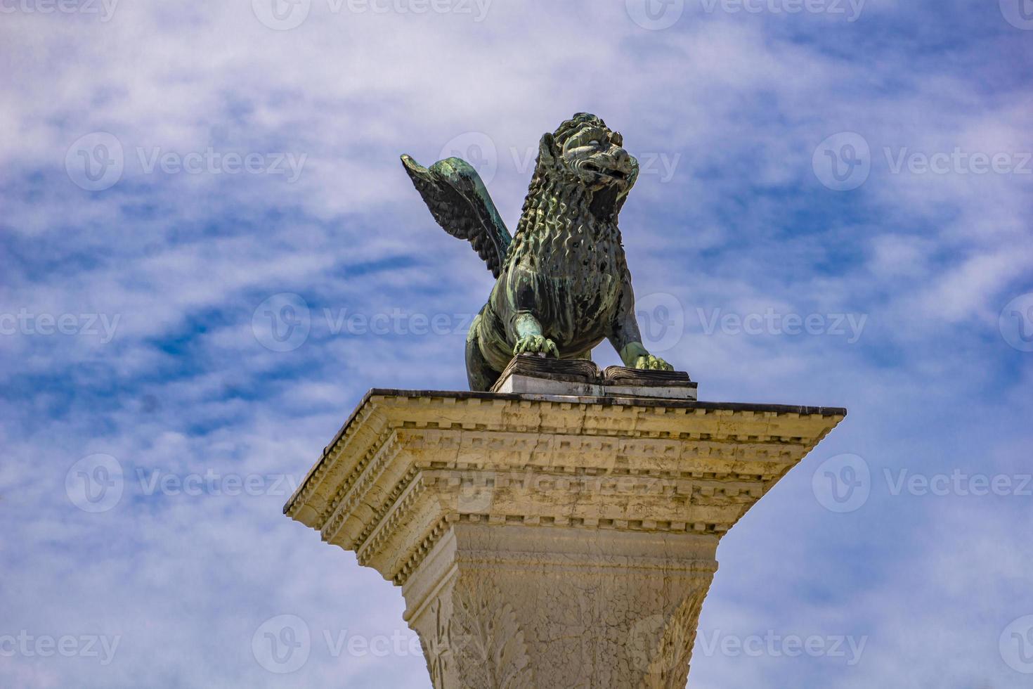skulptur som visar en bild av lejon med vingar, symbol för Venedig, på toppen av kolonnen i San Marco, Italien foto
