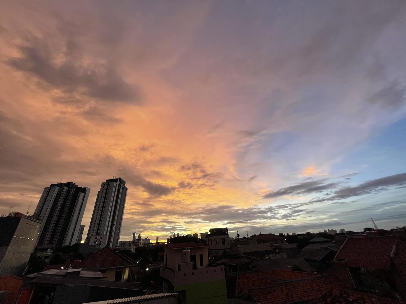 mycket vacker skymningshimmel, en blandning av orange och blå färger. vacker utsikt över kvällshimlen. moln, himmel och regnbåge som pryder atmosfären på eftermiddagen. kvällsvy i jakarta. fläck foto