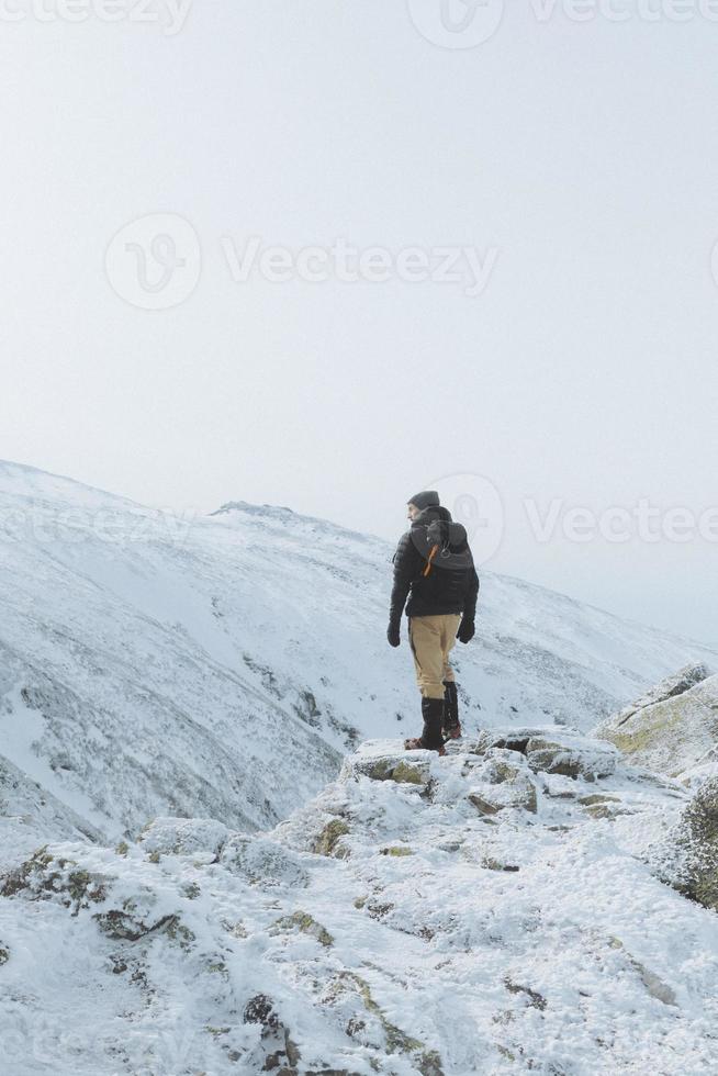 person på kanten av ett berg foto