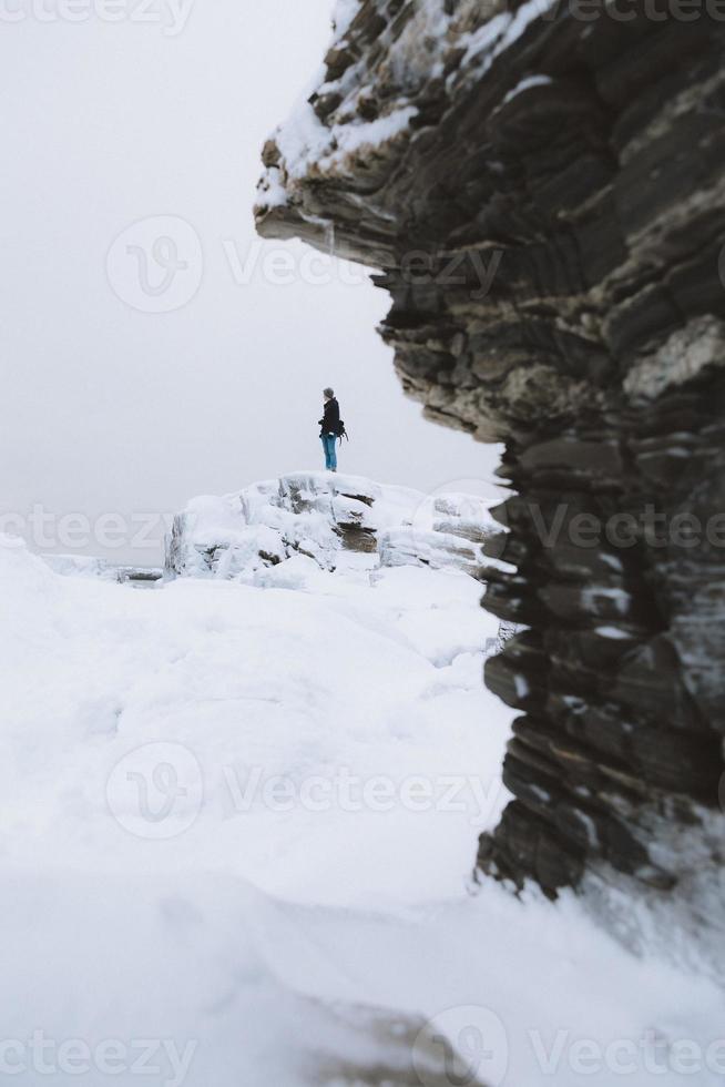 person på en snöig klippa foto