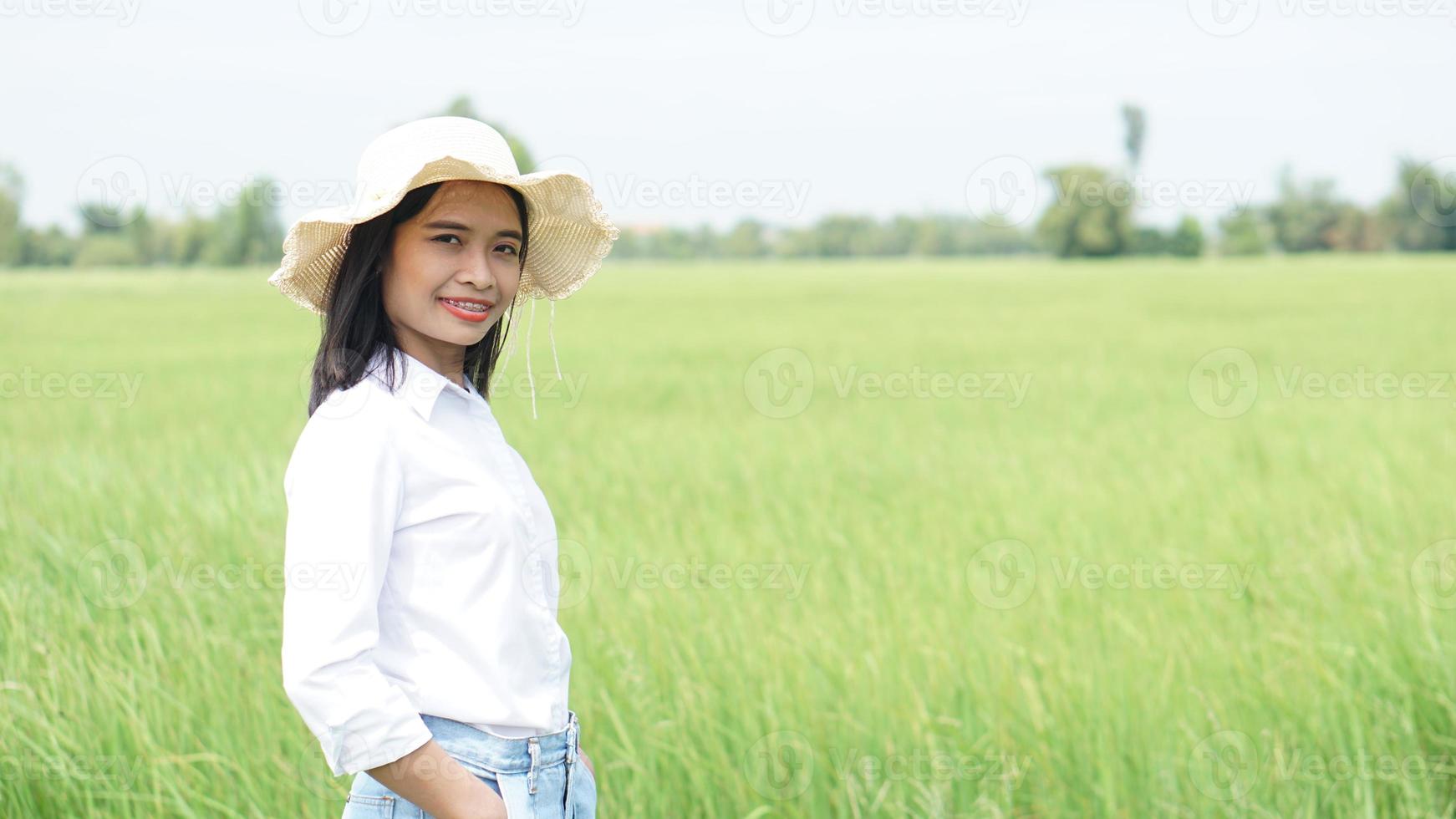 asiatisk kvinna på grönt risfält bakgrund foto